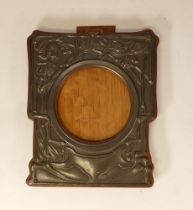 Art Nouveau pewter picture frame on wooden surround. Height 20cm