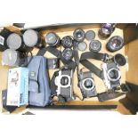 A collection of vintage camera equipment to include Olympus OM-30, Cosina CT-1a & Asahi Pentax