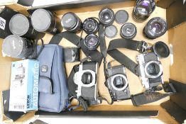 A collection of vintage camera equipment to include Olympus OM-30, Cosina CT-1a & Asahi Pentax