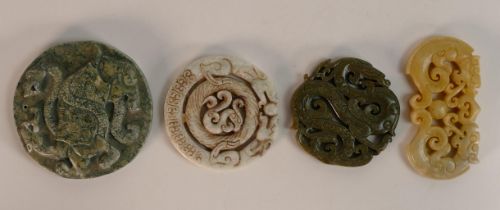 A collection of Chinese carved hardstone roundels in different colours, largest d.8.5cm. (4)