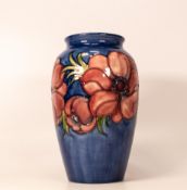 Moorcroft anemone vase on blue background. Paper potters to the late Queen Mary label to base.