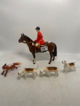 Beswick Huntsman on Brown Horse together with Beswick small standing fox and 3 fox hounds (1 with