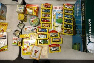 A collection of vintage Rupert The Bear Theme Items including TV Times LLedo Vehicles, tin money