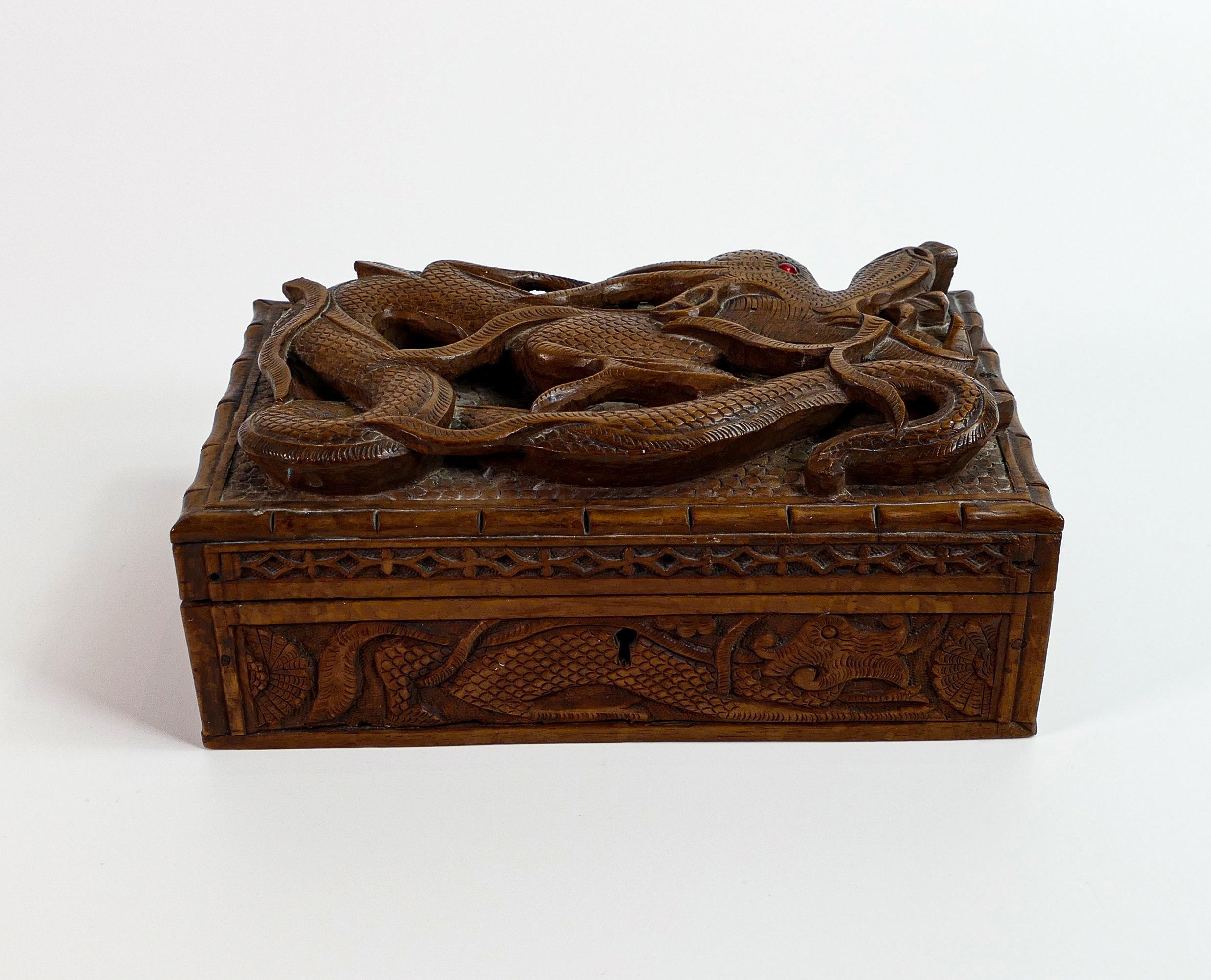 Early 20th century wood box, carved all around with dragons, small piece of carving missing top left