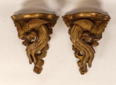 A Pair of 20th Century Wall Brackets moulded with Oriental style rossters and clouds. One tail a/