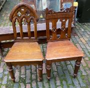 Two non matching mahogany Gothic hall chairs.