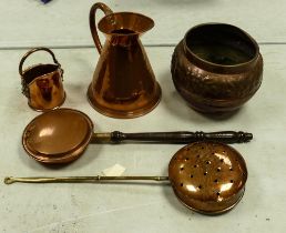 A collection of Copper items to include relief decorated planter, half gallon jug, chestnut toasters