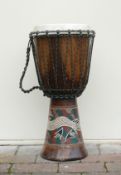 An African Bongo Drum with skin top and painted decoration. Height: 61cm