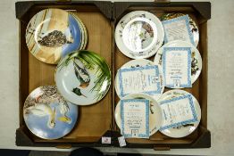 A collection of decorative wall plates to include Wedgwood street sellers and Danbury Mint water