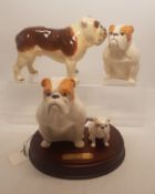 A collection of Beswick dogs to include Seated Bulldog and Pup on wooden plinth together with