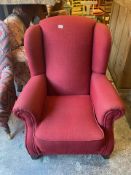 Upholstered Red Armchair on dark hardwood supports 84cm W x 102cm H x 86cm D