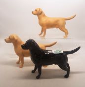 A collection of Beswick dogs to include three labradors, one in black, two golden (3).
