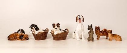 Royal Doulton dogs to include Puppy in basket x 2 , puppy yawning, small Dachshund etc (7)