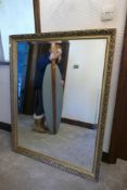 Large gilt framed mirror. 129cm x 100cm slight damage to frame