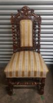 Single Victorian carved oak upholstered dining chair raised on barley twist supports.