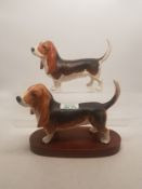 A collection of Beswick dogs to include a Bassett Hound on wooden plinth together with a Bassett