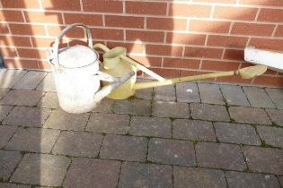 Two vintage metal watering cans