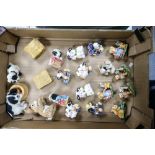 A collection of resin figures to include Beswick Country cousins, paw paw figures and Moo Moo