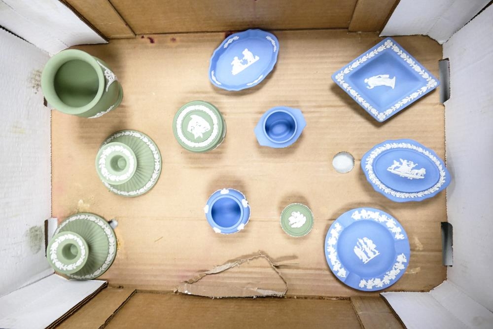 A collection of Wedgwood green and blue jasper ware to include a pair of candlesticks, lidded pot,