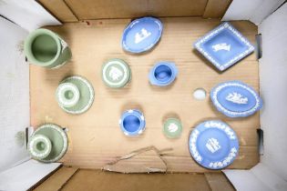 A collection of Wedgwood green and blue jasper ware to include a pair of candlesticks, lidded pot,