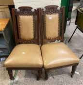 A pair of re-upholstered edwardian carved oak nursing chairs on brass castors 49cm W x 59cm D x 88cm