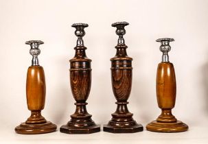 A pair of oak and metal candlesticks together with a similar smaller pair. Height of tallest 30cm (