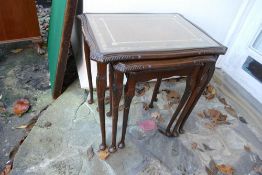 Set of three dark wood glass topped occassional tables