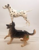 A collection of Beswick dogs to include Dalmation Arnoldene together with an Alsation with paw