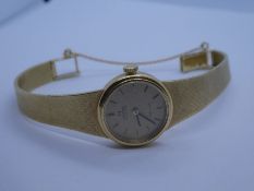 OMEGA; an 18ct yellow gold Ladies Omega de Ville automatic wristwatch, with gold coloured dial and b