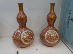 A pair of late 19th century oriental vases, possibly Korean, of double gourd shape, 33cm