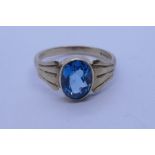 9ct yellow gold dress ring set with an oval mixed cut blue topaz, size J/K, marked 375, approx 2.5g