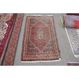 A modern Persian style rug with floral decoration, 146 x 91 cms