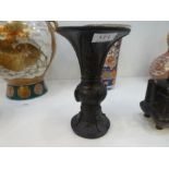An oriental bronze vase having flared rim and a bronze two handled censer having pierced lid