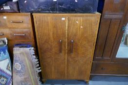 A 1930s cupboard having 3 shelved, a matching chest having 5 long drawers and a bedside oak cupboard