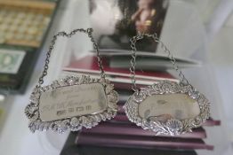 Two silver decorative decanter labels, one Birmingham 1982 EFC, the other by Broadway and Co., Birmi