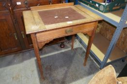 An early 20th century Oak desk having one long drawer with sliding top