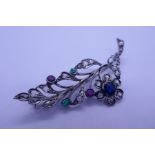18ct white gold brooch in the form of a floral spray, set with diamonds, ruby emeralds, sapphire, 6c