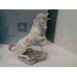 A Lladro model of a seated unicorn from the Privilege collection and another boxed Lladro model of a