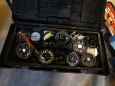 A tool box containing various fishing reels and other accessories and a vintage white painted First