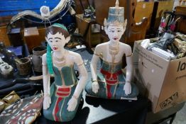 A pair of painted wooden figures of Thai style lady and gent
