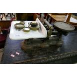 An old set of kitchen scales with assorted weights