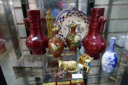 A shelf of oriental items and similar