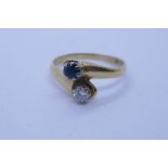 18ct yellow gold sapphire and diamond crossover design ring, size O/P, approx 3.6g, marks worn