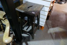 An old smokers bow chair having elm seat and a carved oak table
