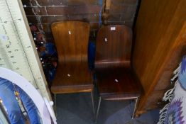 2 Similar 1970s single chairs having metal legs and a large carved wooden fork
