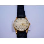 A 9ct gold Rotary wristwatch with a black leather strap. Alternating numerical and baton hour marks,