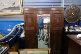 A 1930's Oak wardrobe having central mirror door with long drawer below
