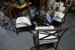 A glass topped square dining table and a set of four matching chairs, all of metal construction