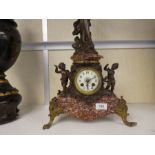 A late 19th century French marble mantle clock having Spelter figures of lady and cherubs, after Mor