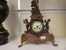 A late 19th century French marble mantle clock having Spelter figures of lady and cherubs, after Mor